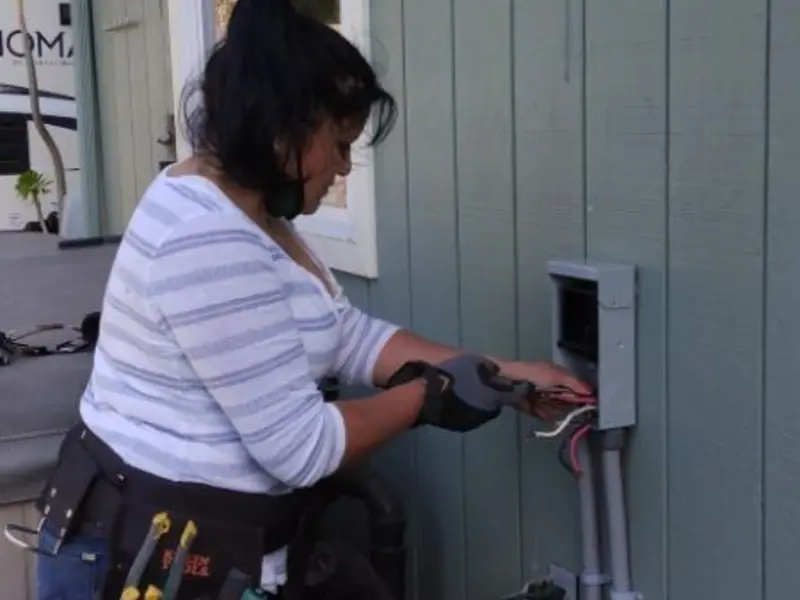 Licensed electrician wiring an exterior subpanel in Atlanta